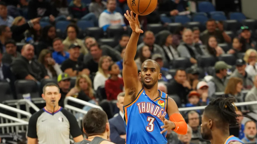 Basketball player Chris Paul attempting to make a throw.