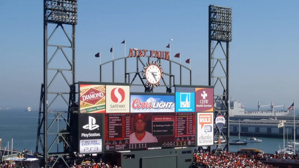 outfield packed bleachers scoreboard featuring lineup and sha