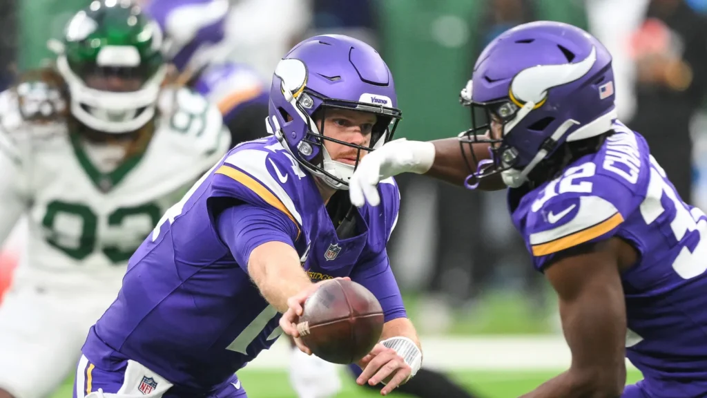 Sam Darnold of the Minnesota Vikings hands the ball off.
