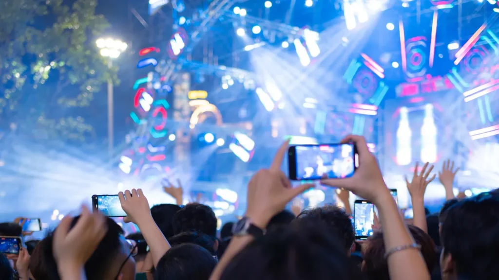 silhouettes of crowd group of people cheering in live music
