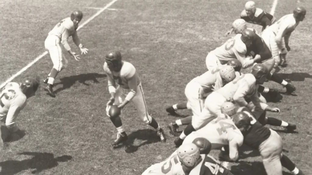 Retro NFL football game action showing players in a pile during a crucial play.