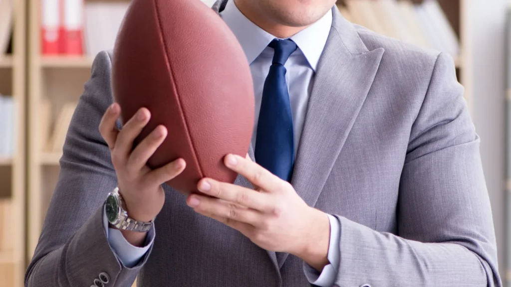 the businessman with american football in office