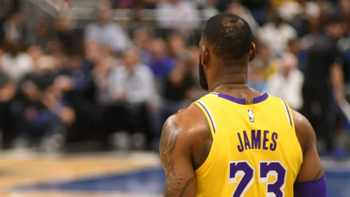 Lebron James standing with his back to the camera in the basketball court.
