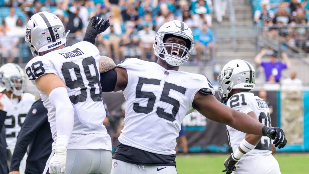 Maxx Crosby celebrating with teammates during an NFL game.