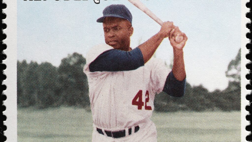 Jackie Robinson swinging a baseball bat.