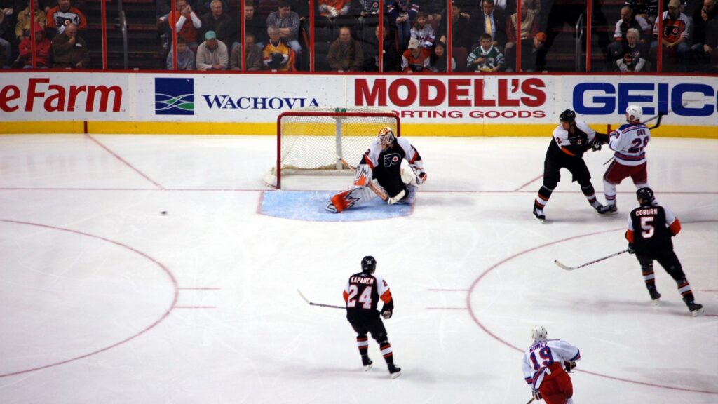 Philadelphia Flyers goalie in a defensive stance during an NHL game.