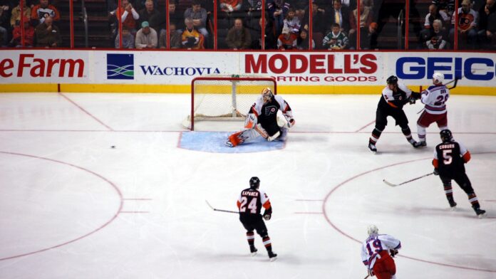 Philadelphia Flyers goalie in a defensive stance during an NHL game.