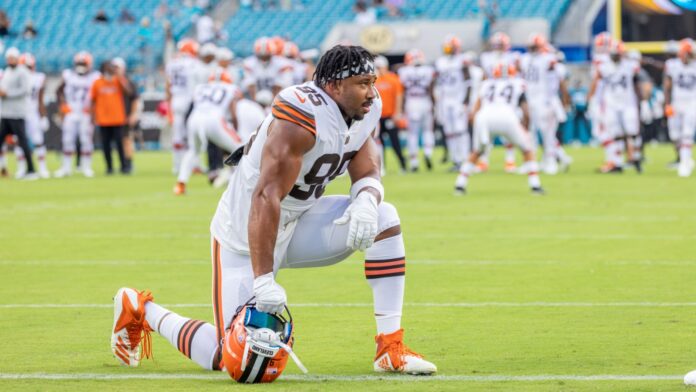 Myles Garrett of Cleveland Browns sitting on one knee in the football ground.