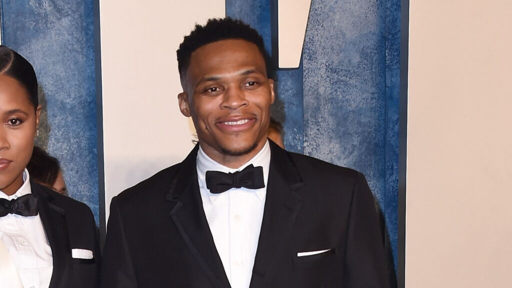 Russell Westbrook smiling into the camera at an event.
