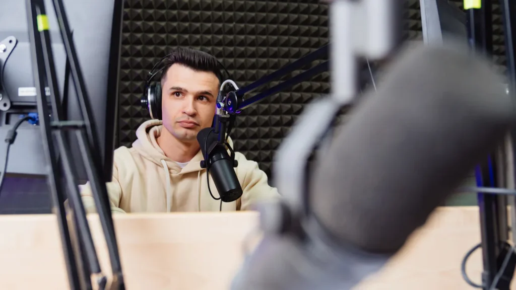 A sports speaker is conduct a live broadcast in a radio studio sports analyst