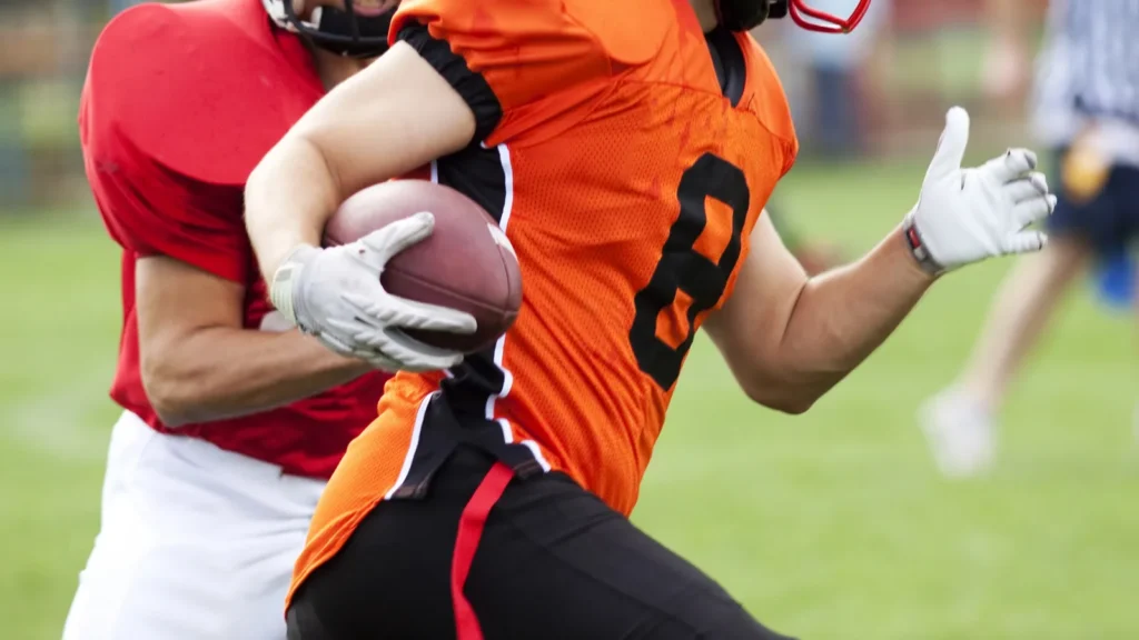 American football players fighting for the ball