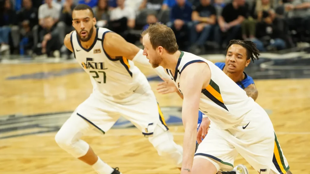 Players of Utah Jazz playing basketball in the court.