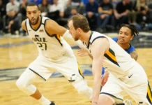 Players of Utah Jazz playing basketball in the court.