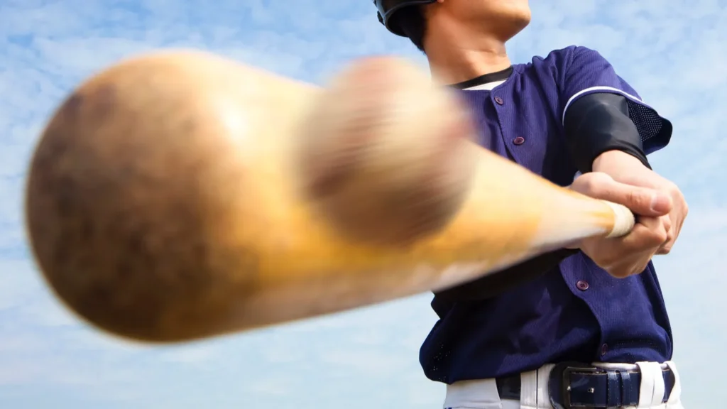 Baseball player hitting the ball with the bat