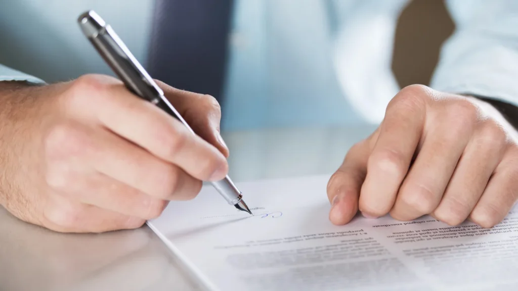 A white person signing business contract.