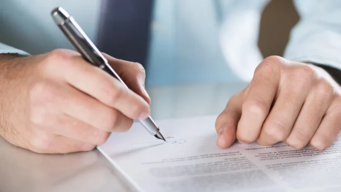 A white person signing business contract.