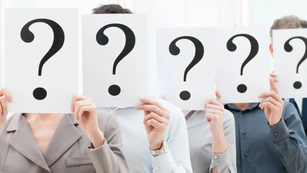 Business team behind question marks