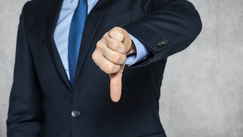 Businessman pointing thumbs down