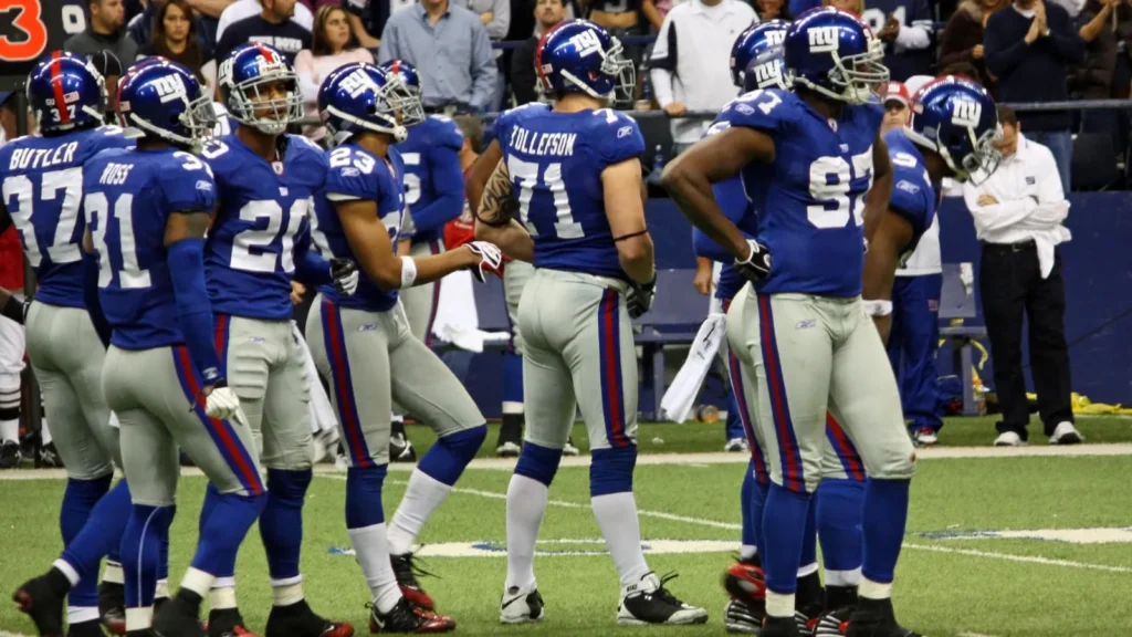 New York Giants' players playing defense during a game.