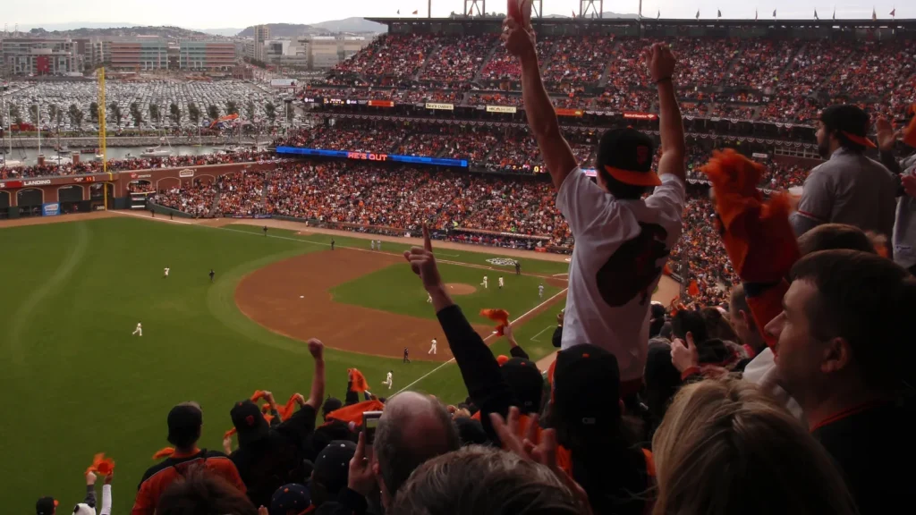 giants fans throughout the ballpark cheer as they raise hands