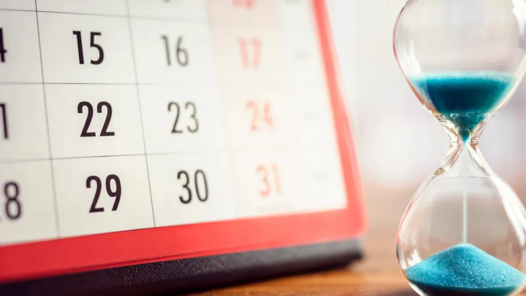Hour glass and calendar concept for time slipping away for important appointment date schedule and deadline