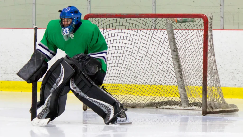 An ice hockey goaltender in action.