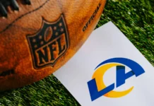 S Kam Curl agrees to three-year $36 million deal to remain with the Los Angeles Rams Official NFL football alongside a paper displaying the logo for the Los Angeles Rams