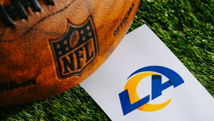 Official NFL football alongside a paper displaying the logo for the Los Angeles Rams