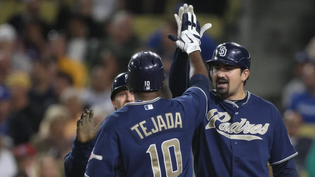 MIGUEL TEJADA and ADRIAN GONZALEZ celebrate scoring with a high five during the game