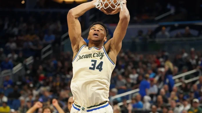 Milwaukee Bucks player Giannis Antetokounmpo makes a dunk.