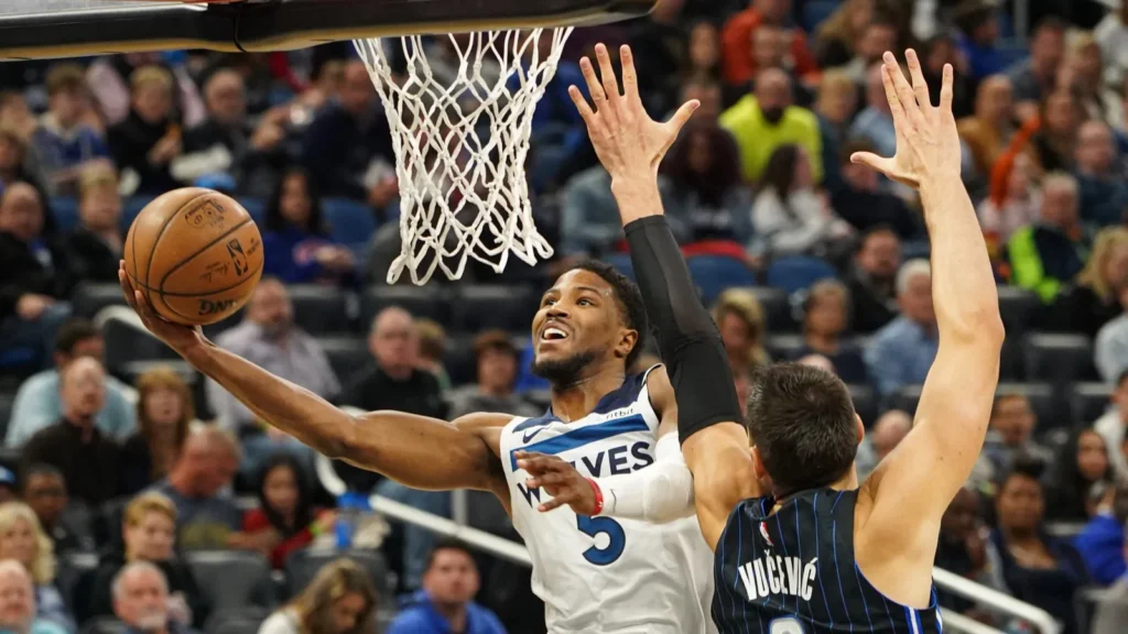 Minnesota Timberwolves  Anthony Edwards aiming for the net.