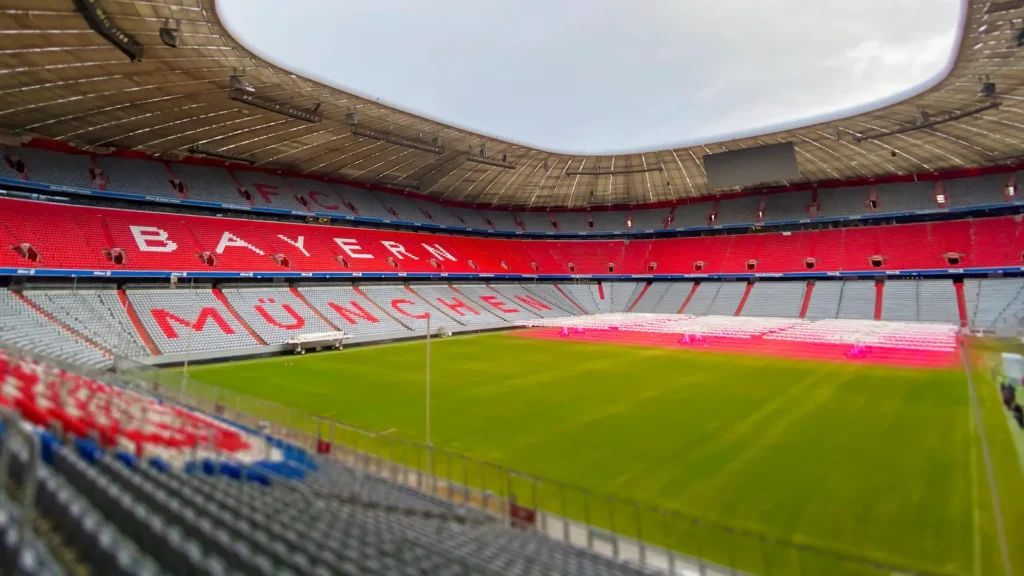 Munich DE Dec 22 2022 The empty interior of Allianz Arena home stadium of FC Bayern Munich showing the iconic red seating and the field The arena is prepared for an upcoming event
