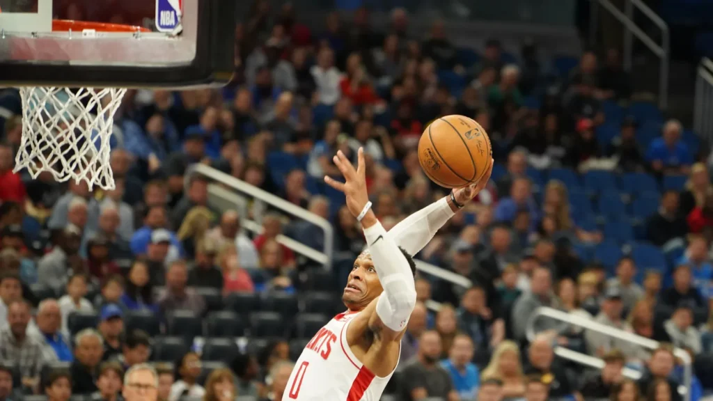 Houston Rockets' player shooting the ball through net.