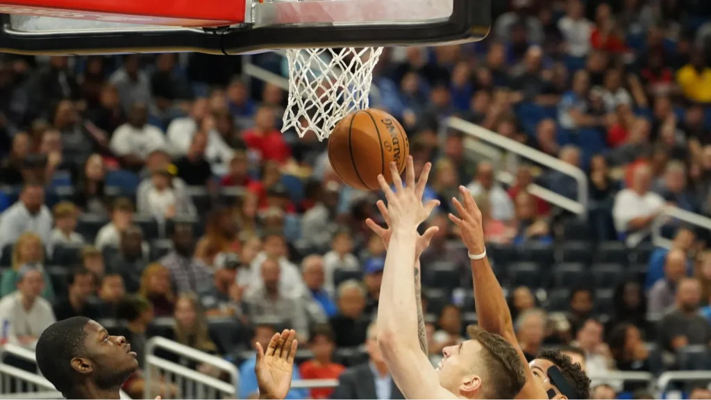 Houston Rockets player shooting ball through the net.
