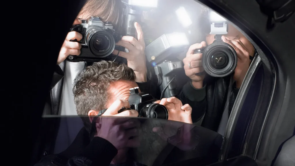 Paparazzi photographers near car