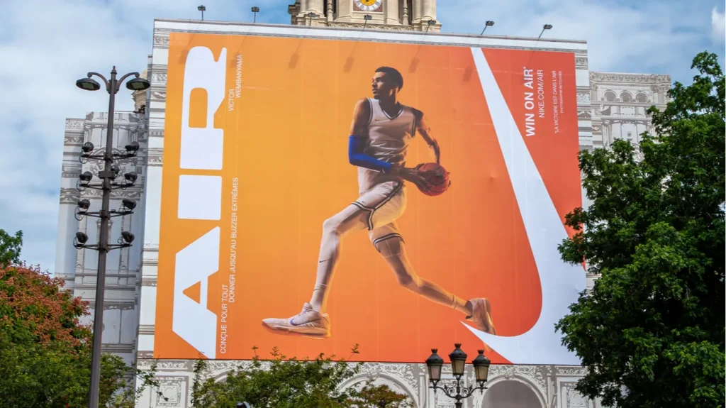 Paris France  July 25 2024 Large advertising billboard for Nike Air starring French basketball player Victor Wembanyama over the scaffoldings on the facade of SainteTrinit catholic church