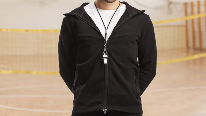 pe teacher posing in a school gymnasiu