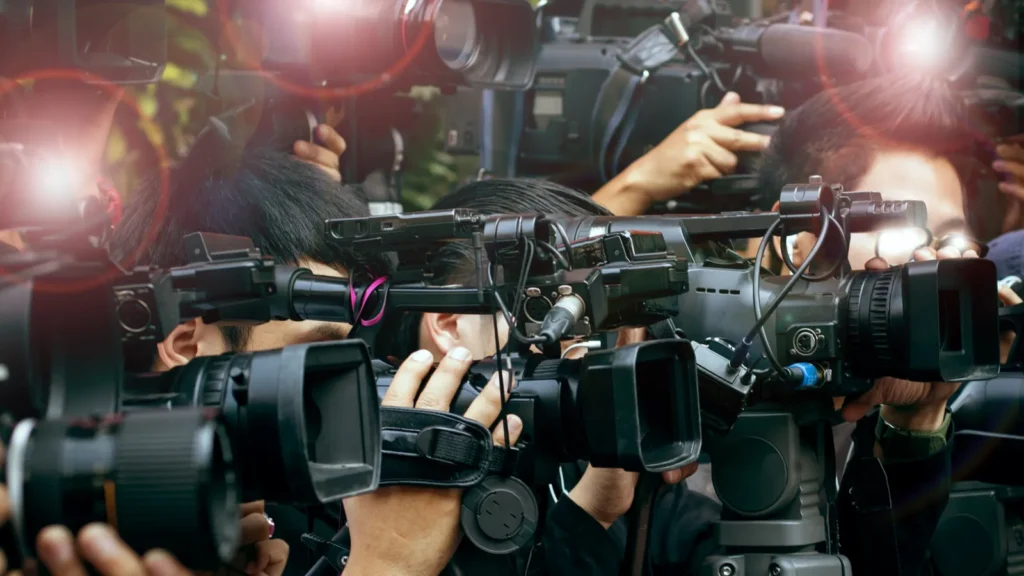 press and media camera video photographer on duty in public