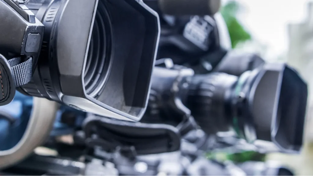 Professional tv cameras on tripods recording social event on the street