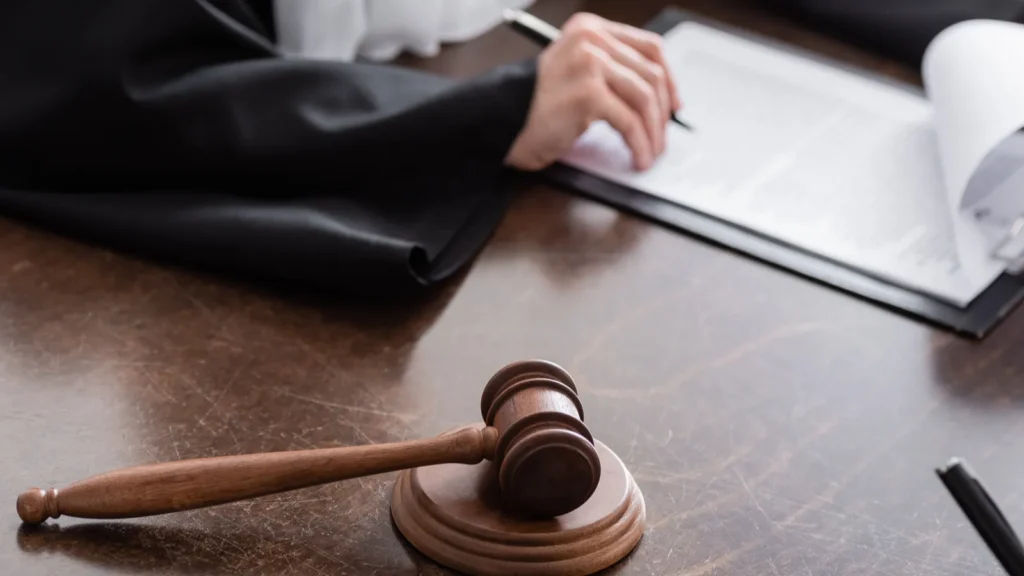 Selective focus of wooden gavel near cropped judge
