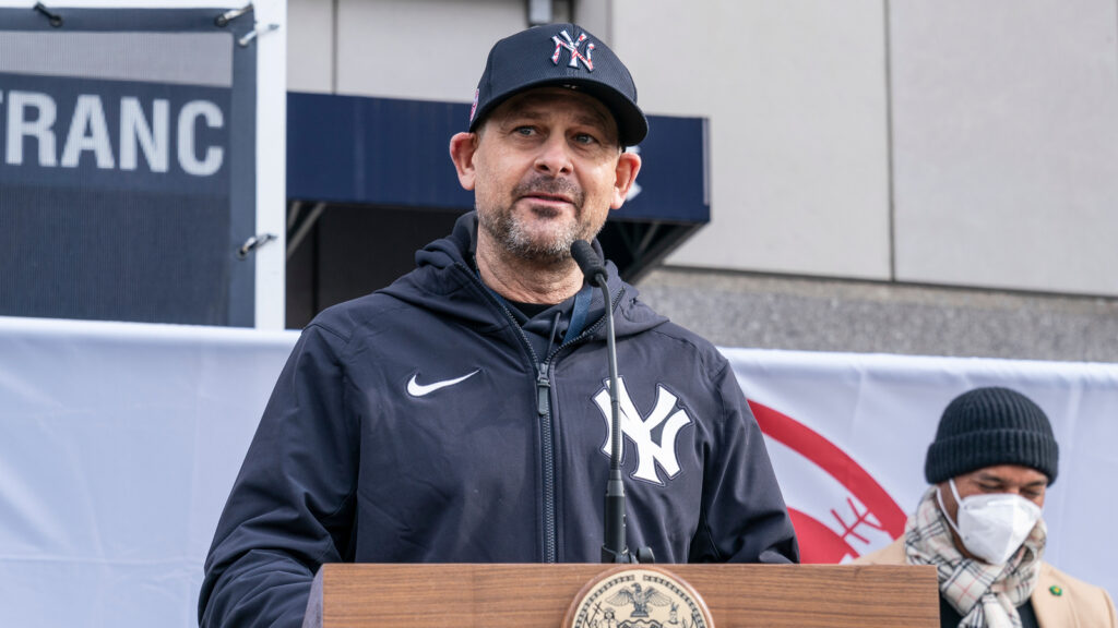 Aaron Boone speaks at a conference