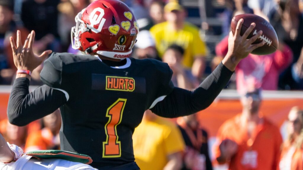 Jalen Hurts attempts to throw football