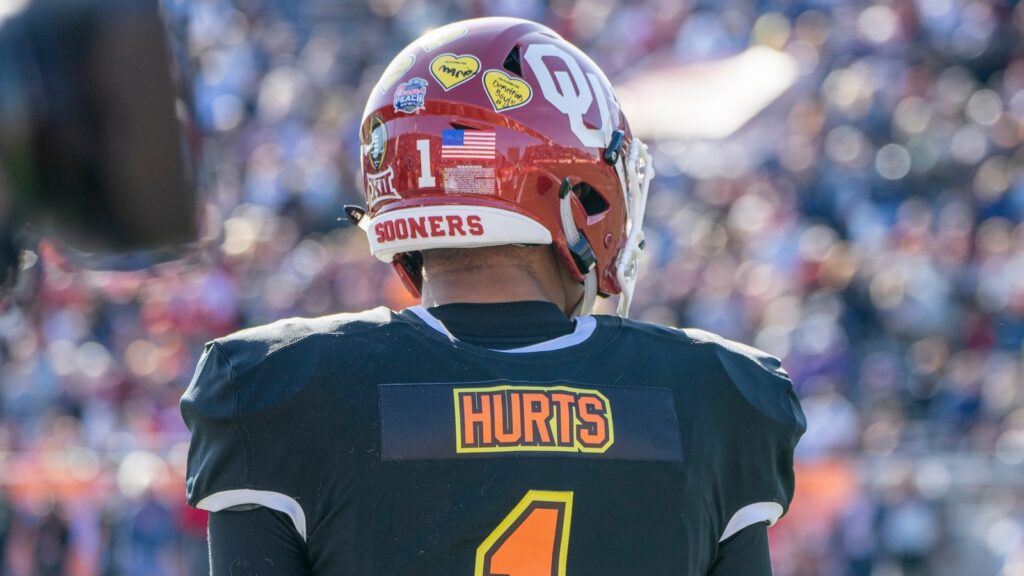 Jalen Hurts looks onto the field