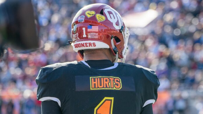 Jalen Hurts looks onto the field