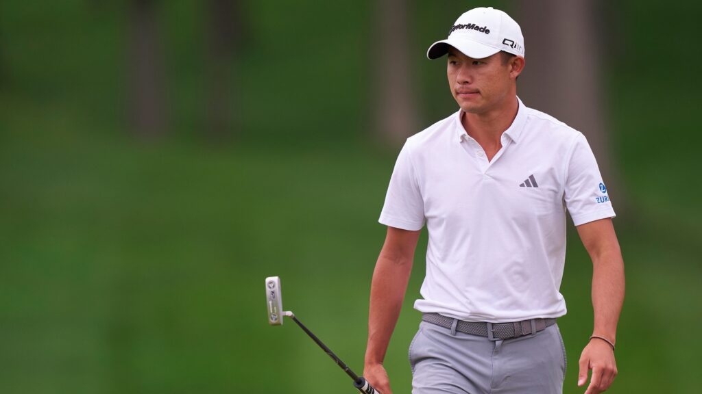 Collin Morikawa walking during a golf game.
