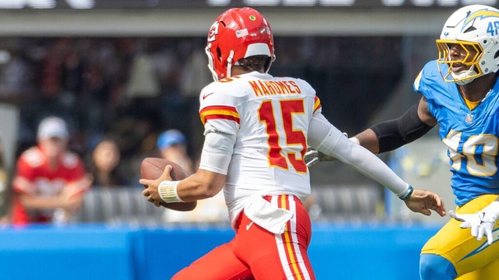 Patrick Mahomes runs to escape a tackle