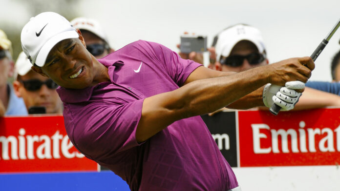 Tiger Woods playing a tee shot wearing Nike