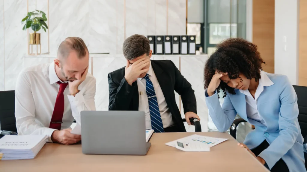 Team thinking of problem solution at office meeting sad diverse business people group shocked by bad news upset colleagues in panic after company bankruptcy concep