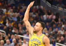 Stephen Curry’s latest achievement rewrites Hall of Fame history Stephen Curry lifts his hand during a basketball game