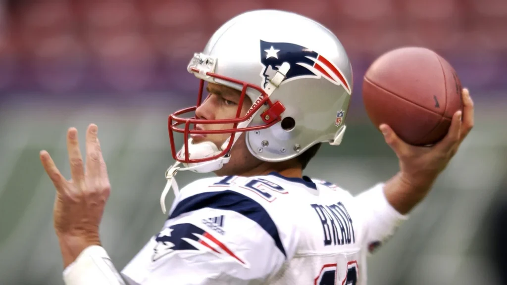 Tom Brady, the quarterback throwing a football during an NFL game.
